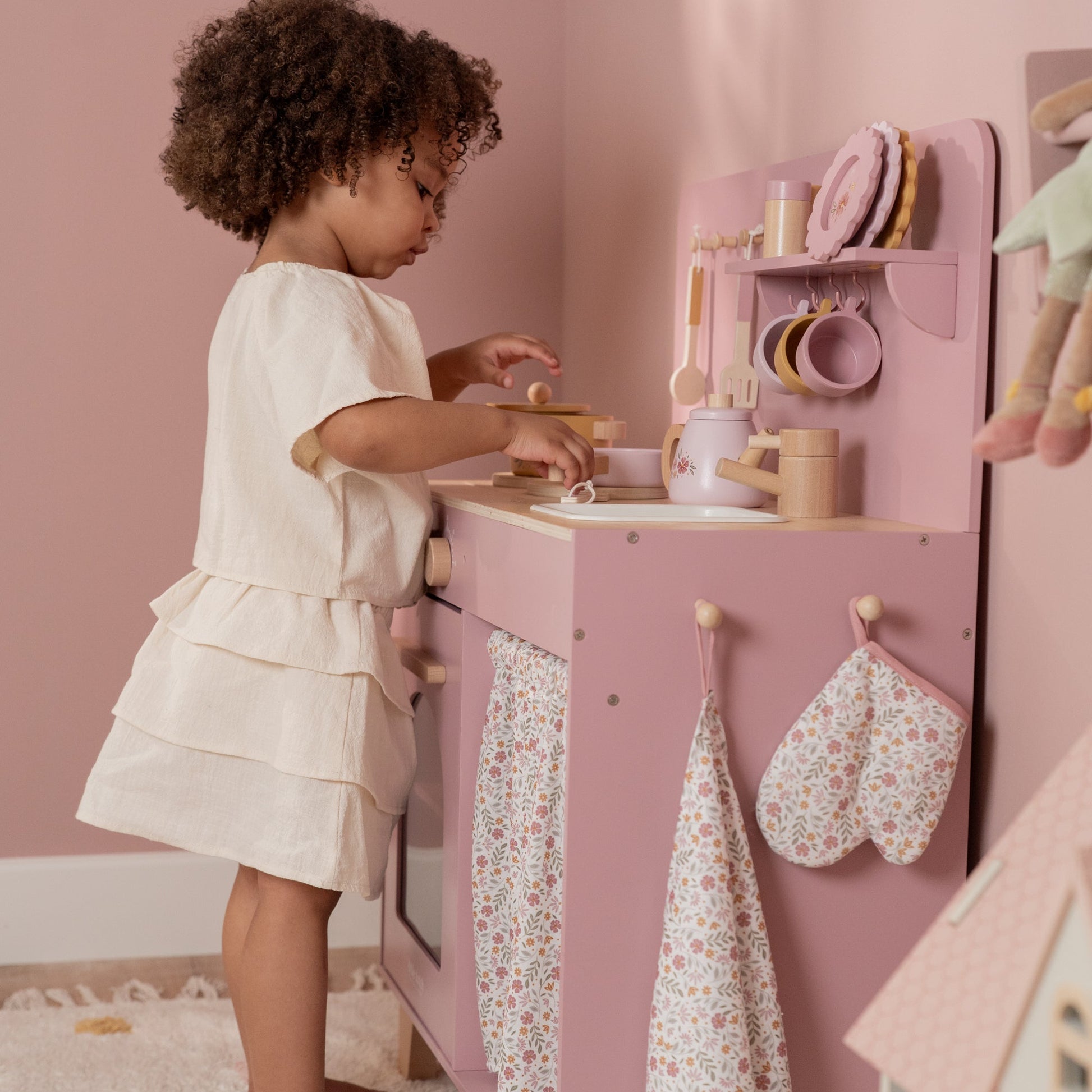 Child playing with Little Dutch wooden kitchen set